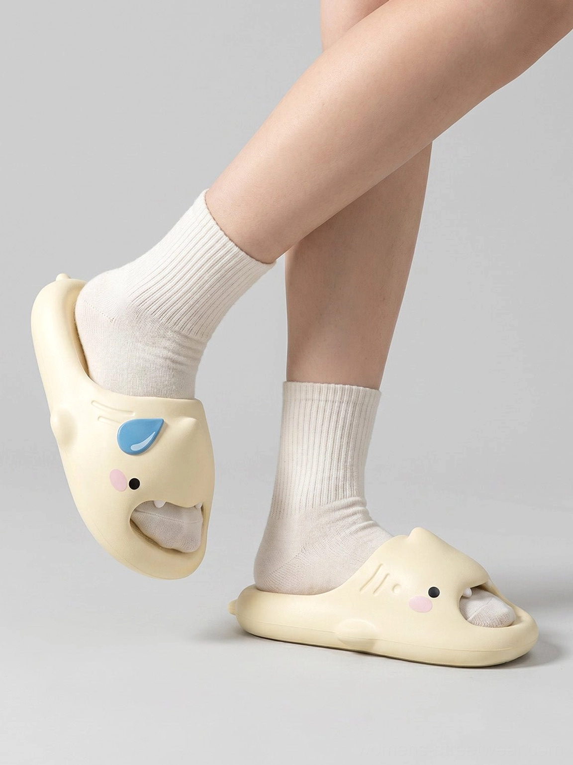 Angled side view of shark slide slippers worn with socks showing the comfortable open-toe platform silhouette