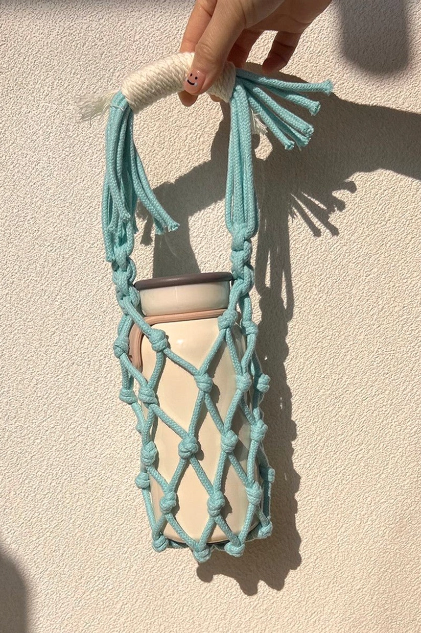 Cyan blue cotton macrame water bottle carrier with woven net pocket and tassel handle for beach trips, festivals, and daily wear