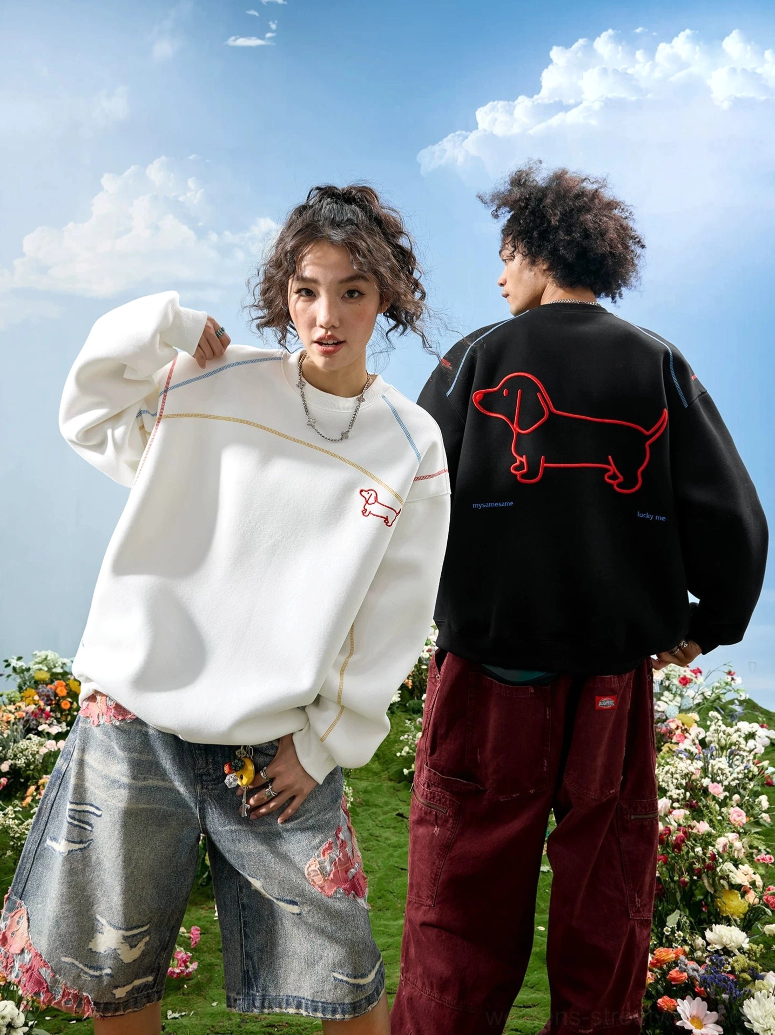 Black and white dachshund embroidered oversized streetwear sweatshirts shown from side and back views on two models with red dog embroidery