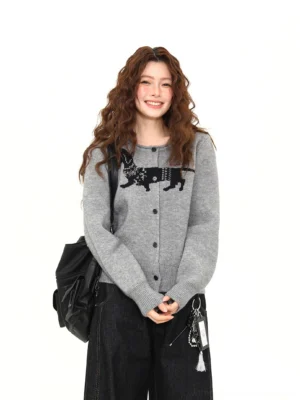 Front view of a heather gray dachshund jacquard knit cardigan with black dog motif, round neckline, button front, relaxed fit, and ribbed trims styled with black wide-leg jeans
