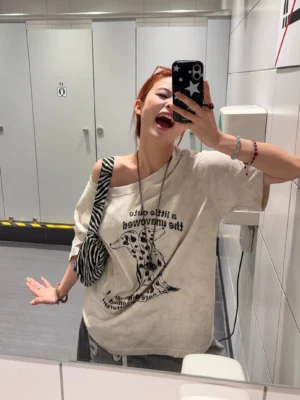 Apricot Dalmatian graphic oversized T-shirt styled off one shoulder with washed vintage fabric, bold dog illustration, zebra crossbody bag and streetwear accessories