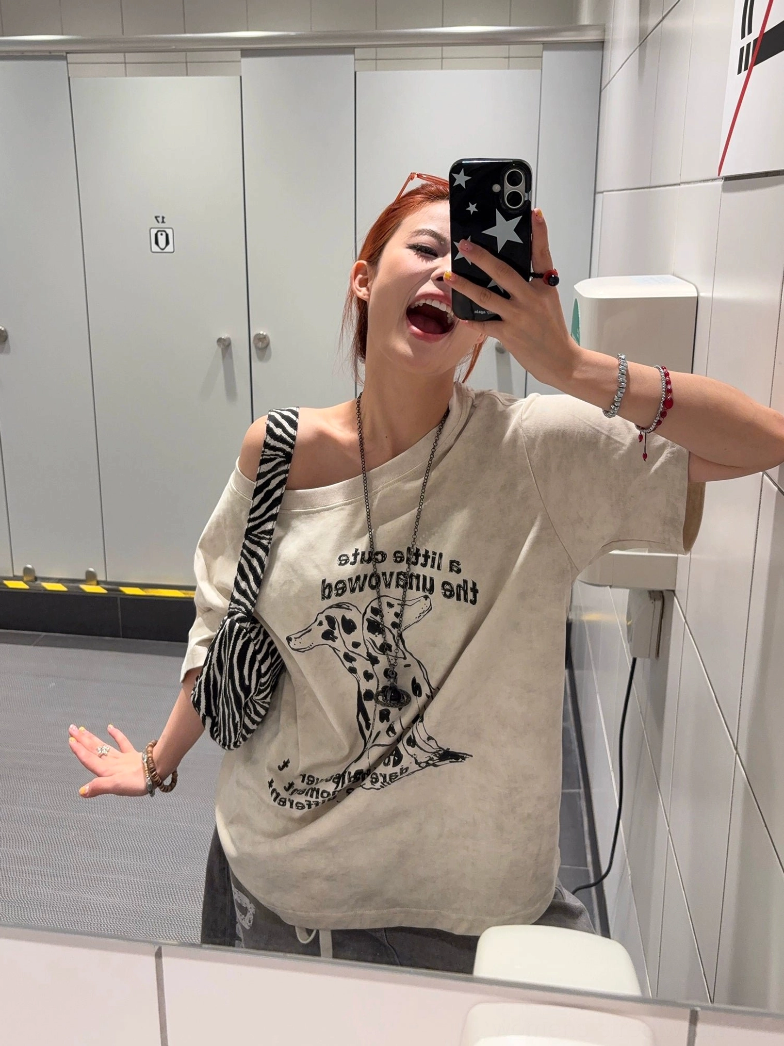 Apricot Dalmatian graphic oversized T-shirt styled off one shoulder with washed vintage fabric, bold dog illustration, zebra crossbody bag and streetwear accessories