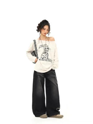 Apricot Dalmatian print off-shoulder long sleeve tee with dropped shoulders styled with wide-leg jeans and zebra handbag