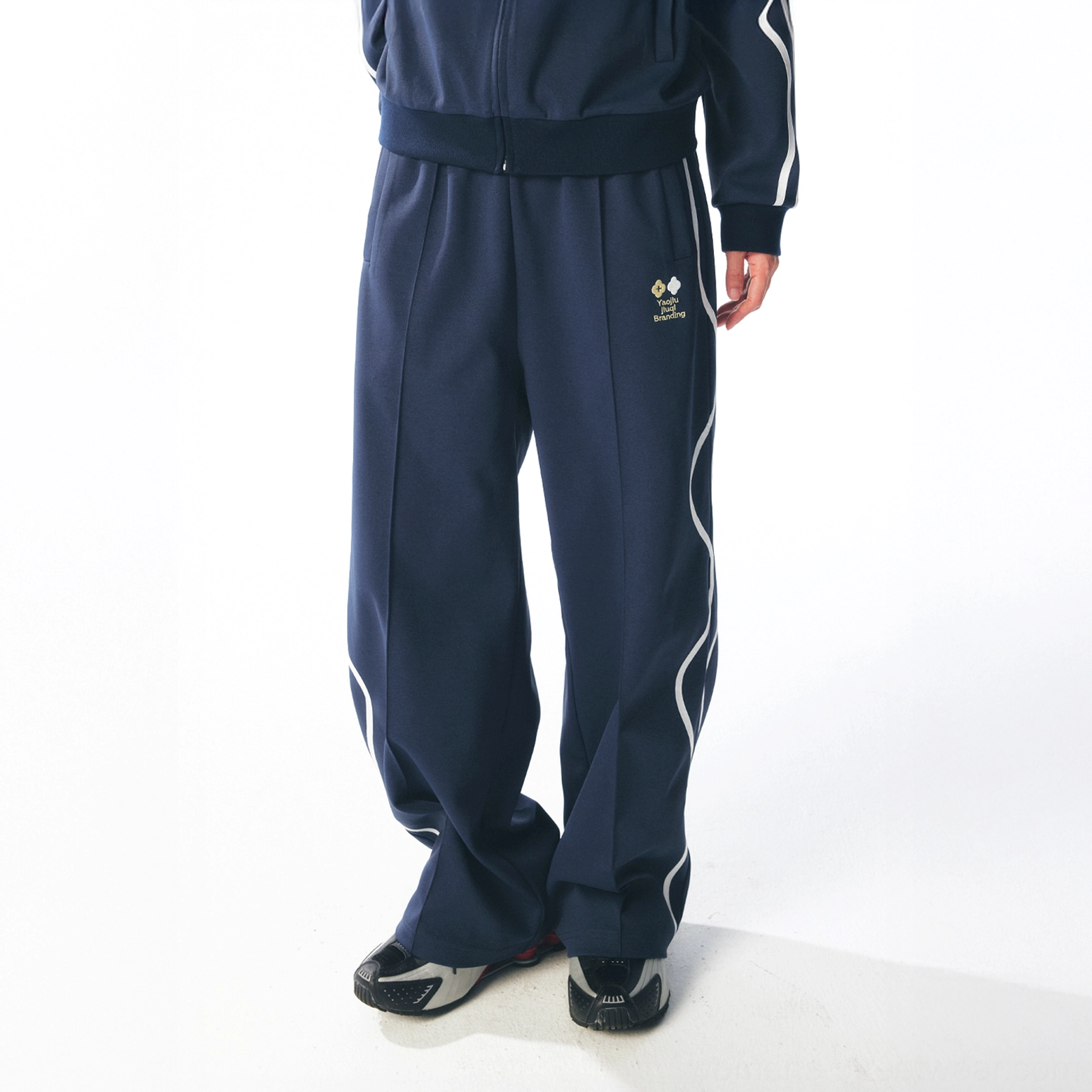 Dark blue curved stripe quick-dry track pants styled with a matching track jacket and white side stripes
