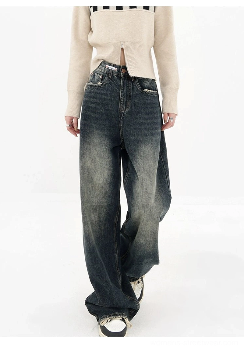 Dark blue high-waisted wide-leg jeans front three-quarter view with faded vintage wash and frayed hem