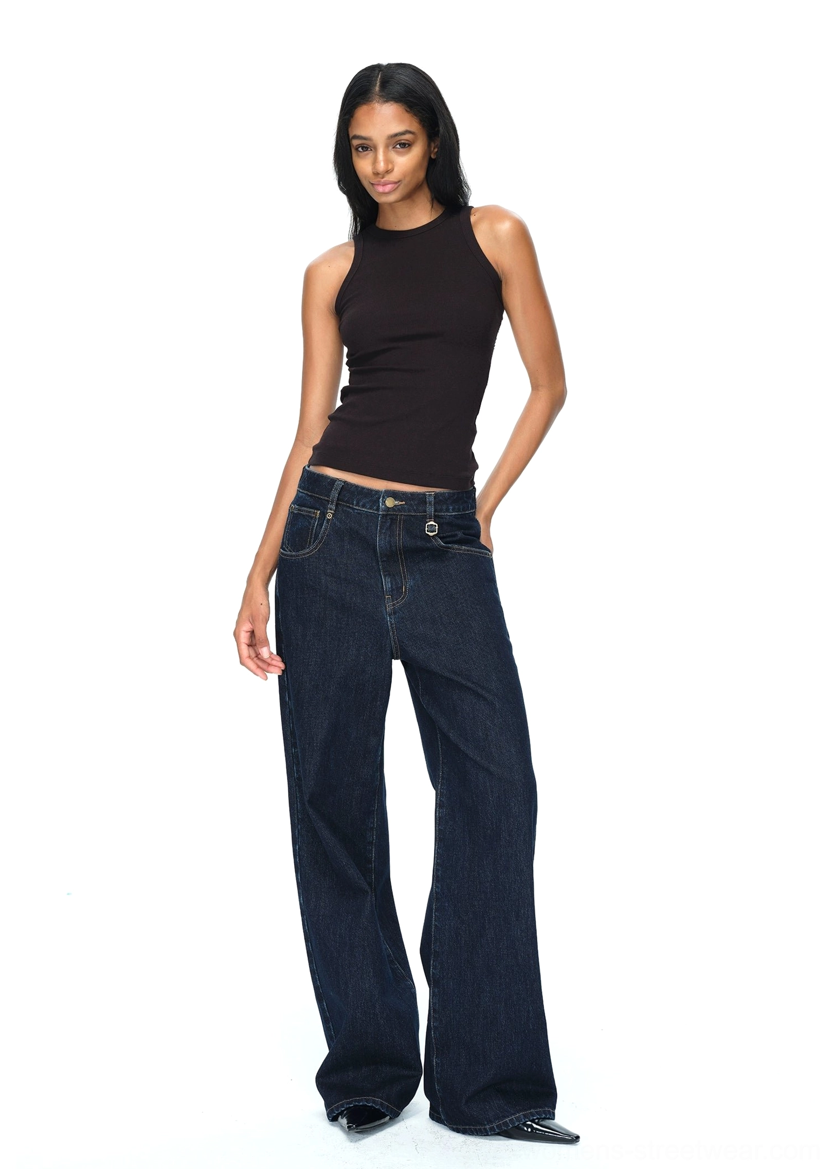 Dark blue raw denim jeans with high-waisted proportions, practical pockets, and modern wide-leg streetwear design