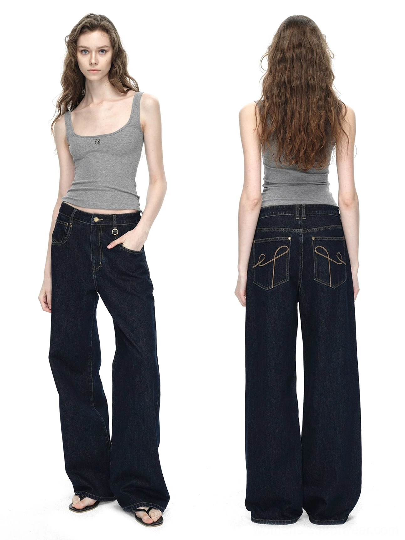Front three quarter view of dark blue raw denim wide-leg jeans with high waist and relaxed streetwear silhouette