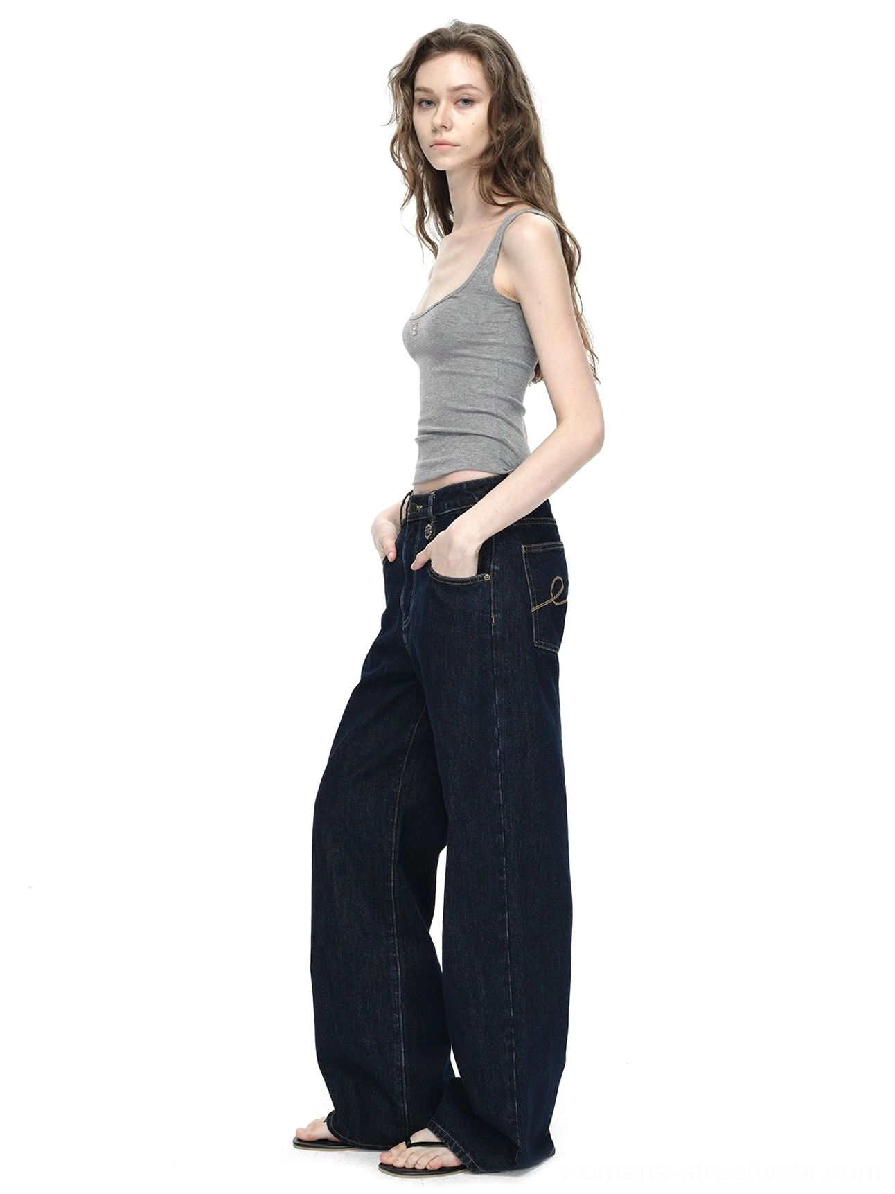 Low angle front view showing the long wide-leg cut, belt loops, and dark raw denim construction