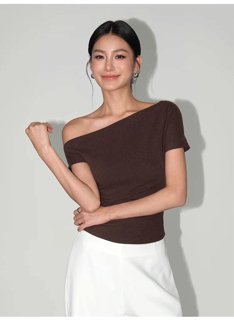 Dark brown asymmetric off-shoulder short-sleeve T-shirt showing the fitted slim silhouette and sculpted neckline