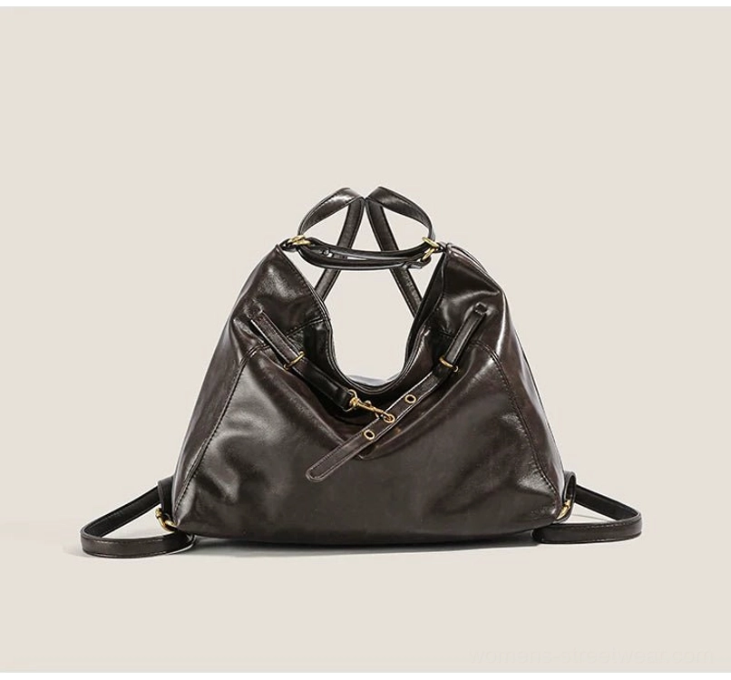 Dark brown buckle detail hobo bag shown from a top-down front angle with doubled shoulder straps, decorative front hardware, and structured slouchy shape