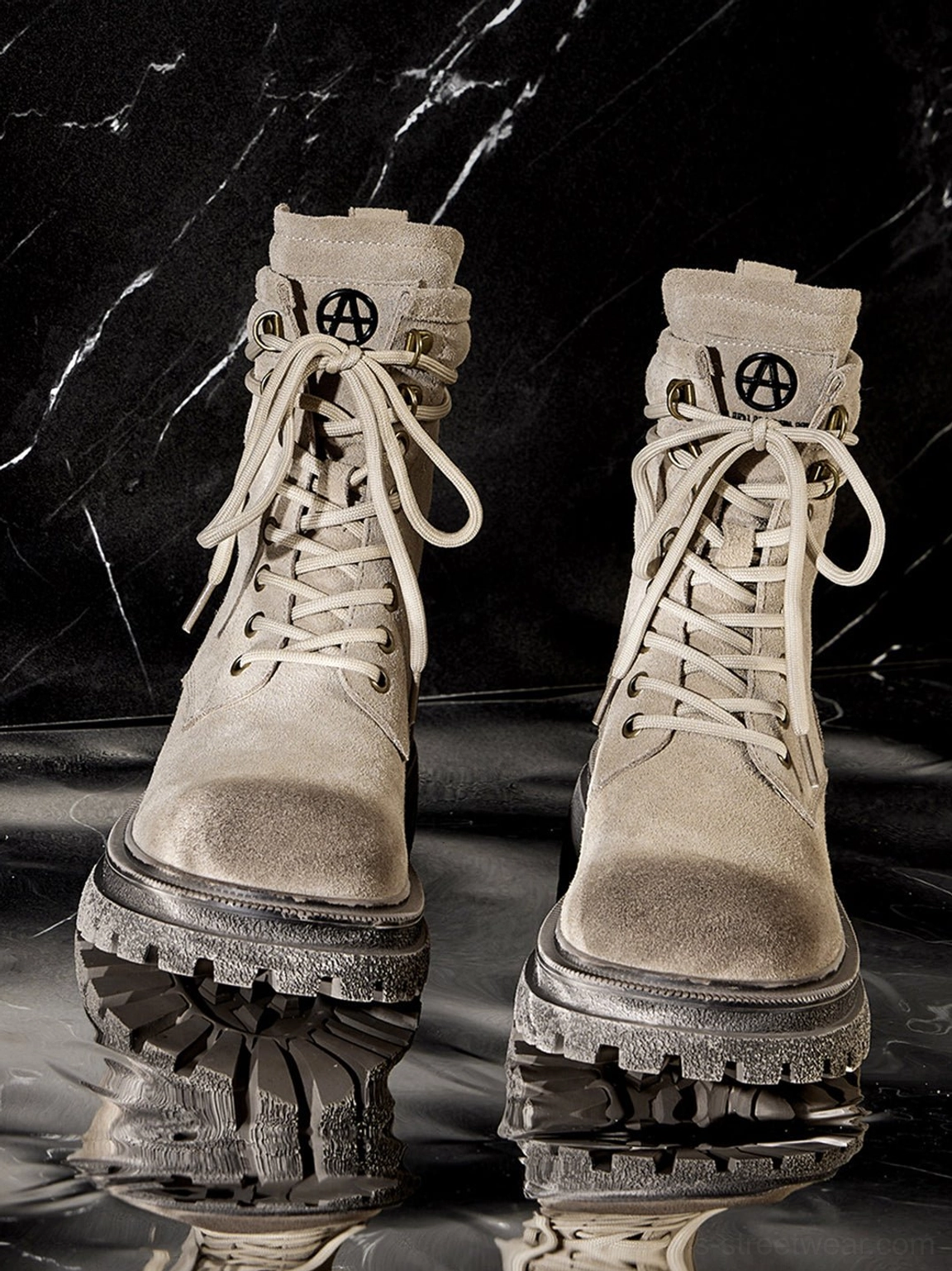 Dark brown distressed combat boots displayed on minimal background emphasizing silhouette and platform sole presence