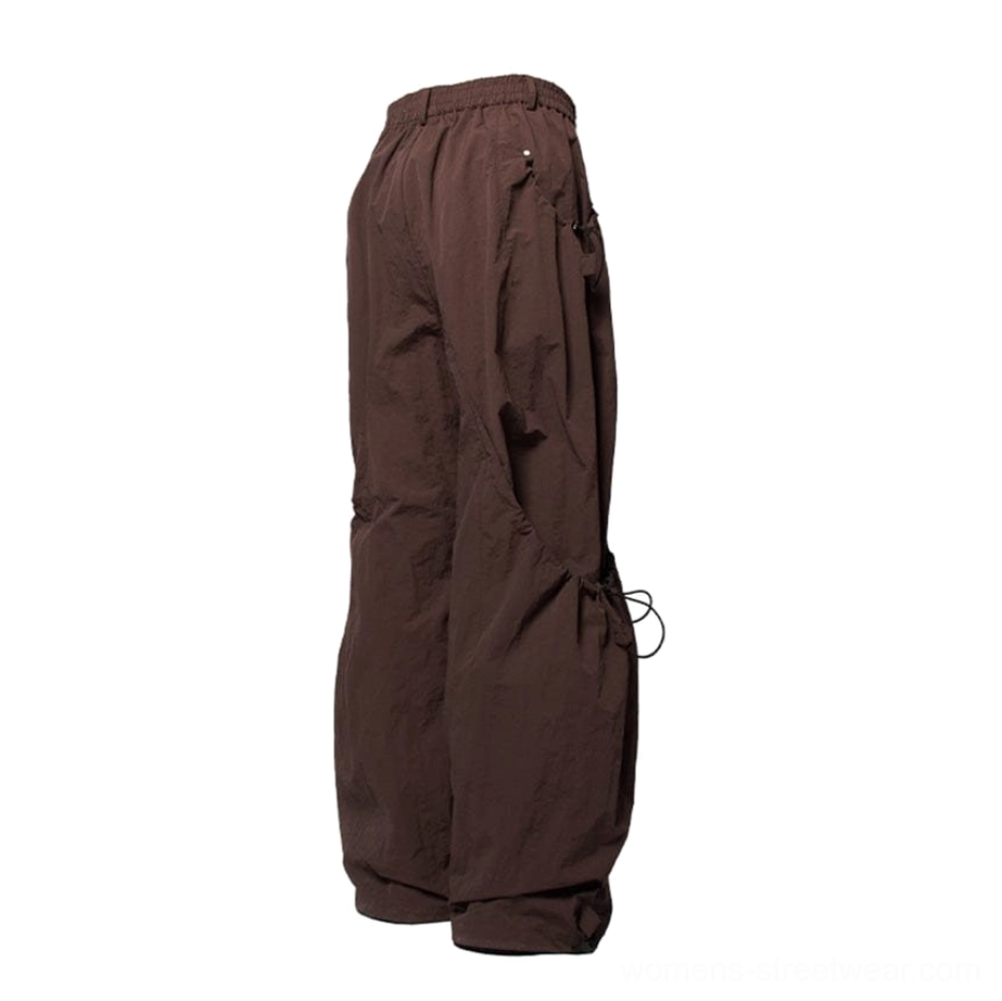 Rear view of dark brown drawstring wide leg cargo pants showing elasticated back waist and adjustable hem details
