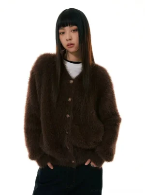 Dark brown faux fur button-up cardigan sweater with V-neck, round metal buttons, relaxed fit, and white top styling