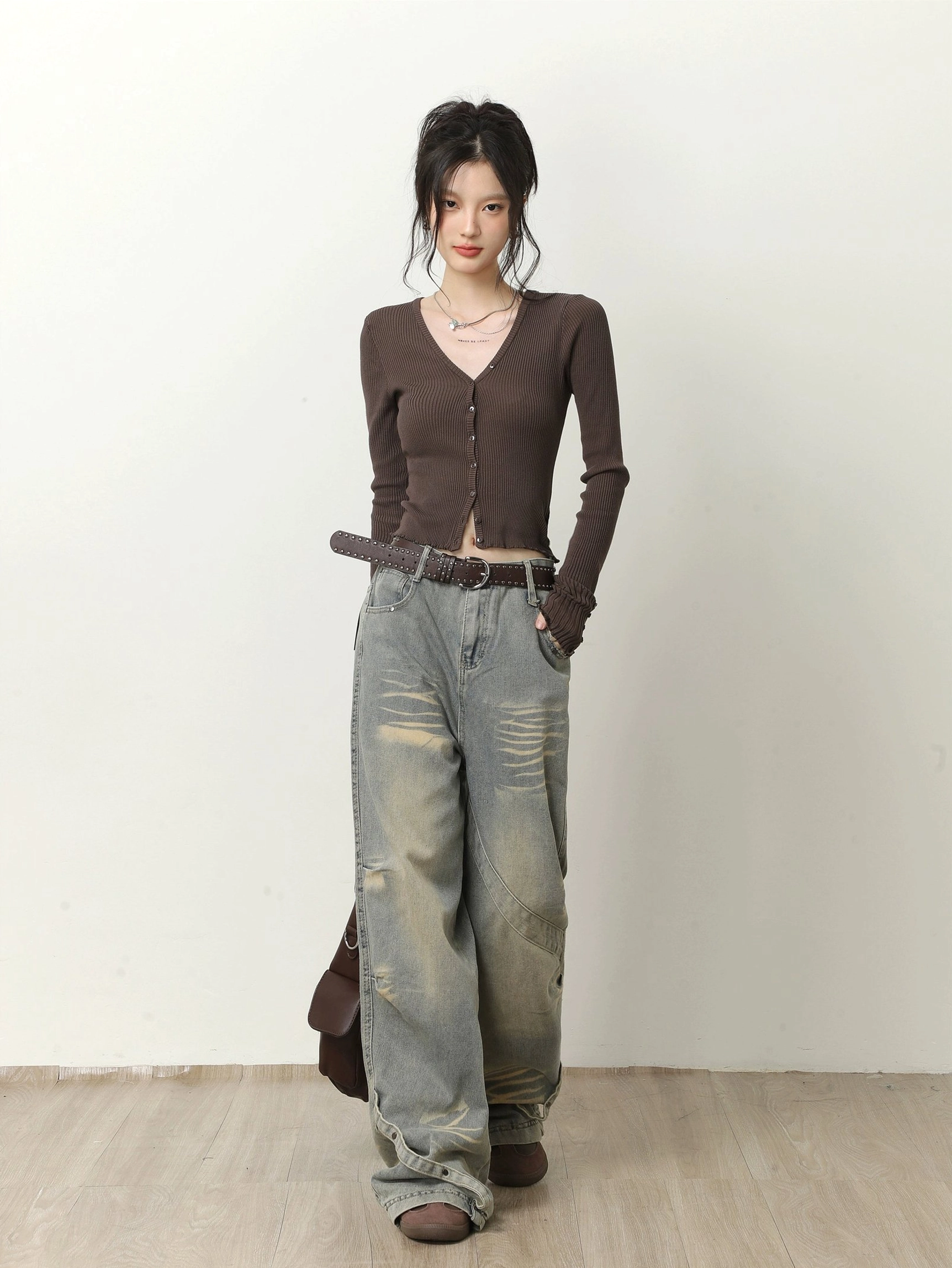 Dark brown fitted cropped V-neck ribbed cardigan with button closure styled with vintage washed blue wide-leg jeans