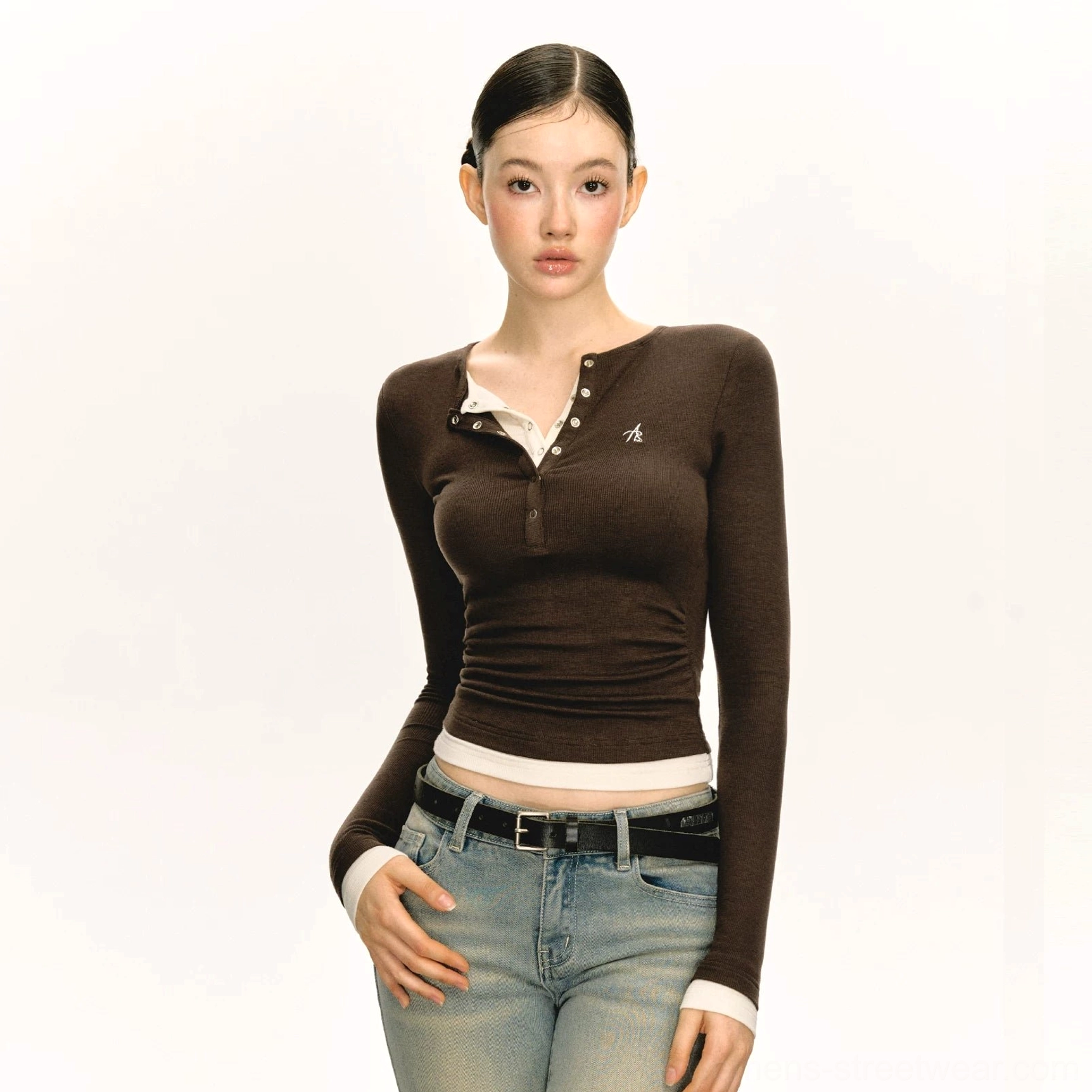 Dark brown fitted layered Henley long sleeve streetwear top with embroidered chest detail styled with blue denim jeans