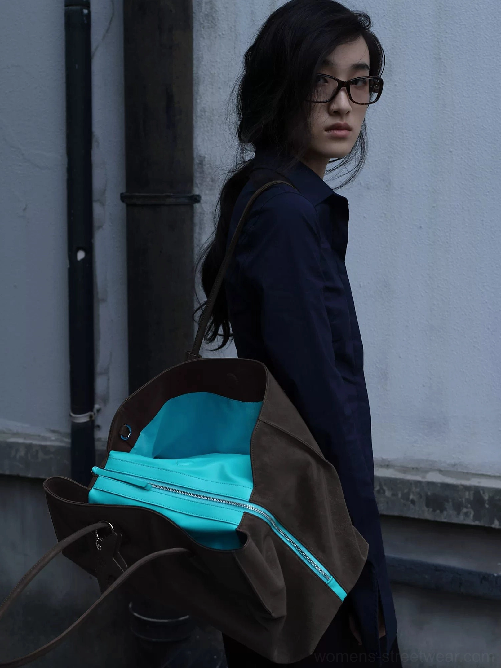 Dark brown matte suede-look commuter tote bag with turquoise lining and secure zipper closure shown from the rear