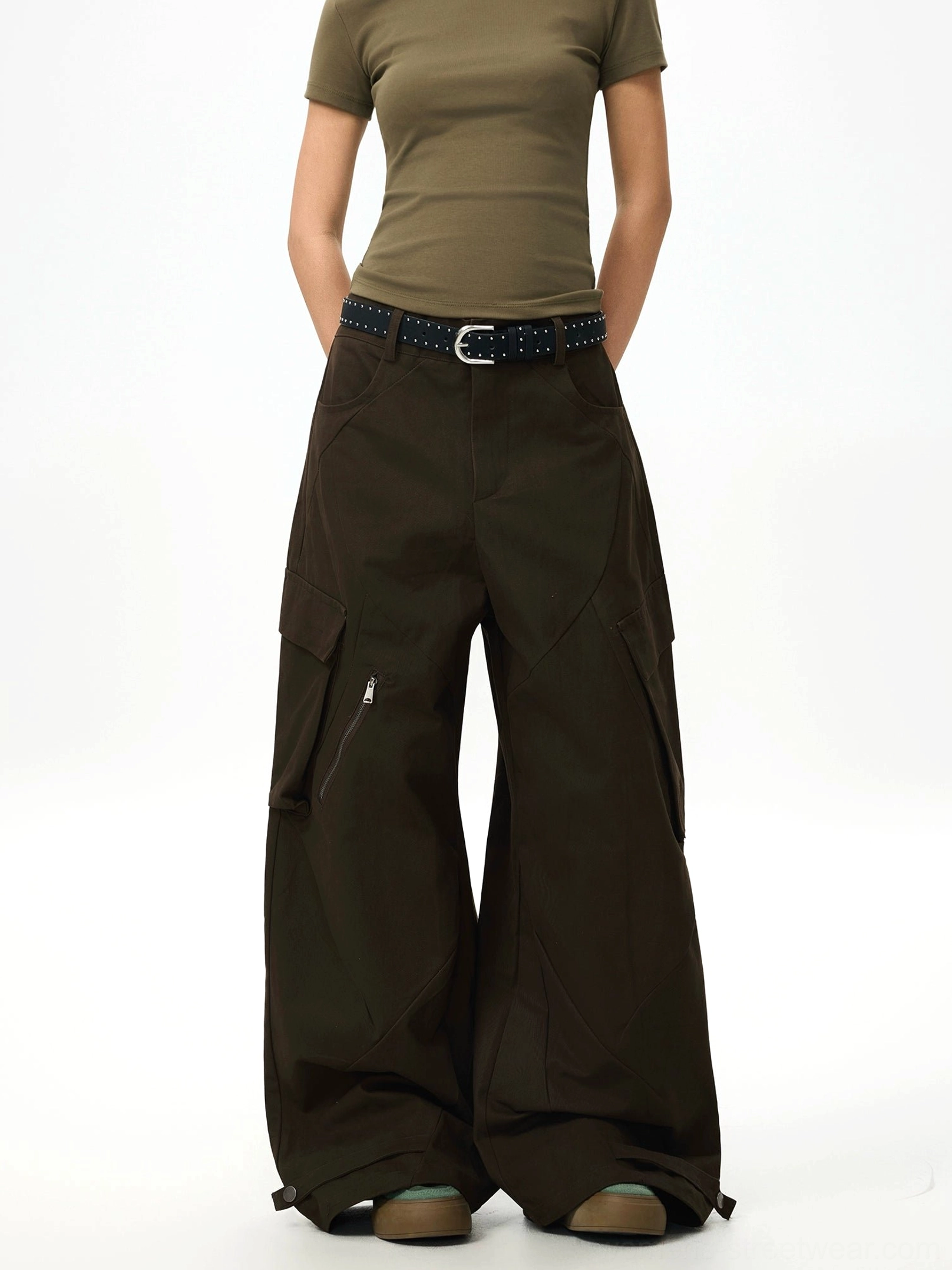 Front view of dark brown oversized cargo pants with large rear pockets adjustable ankle straps and contemporary techwear details