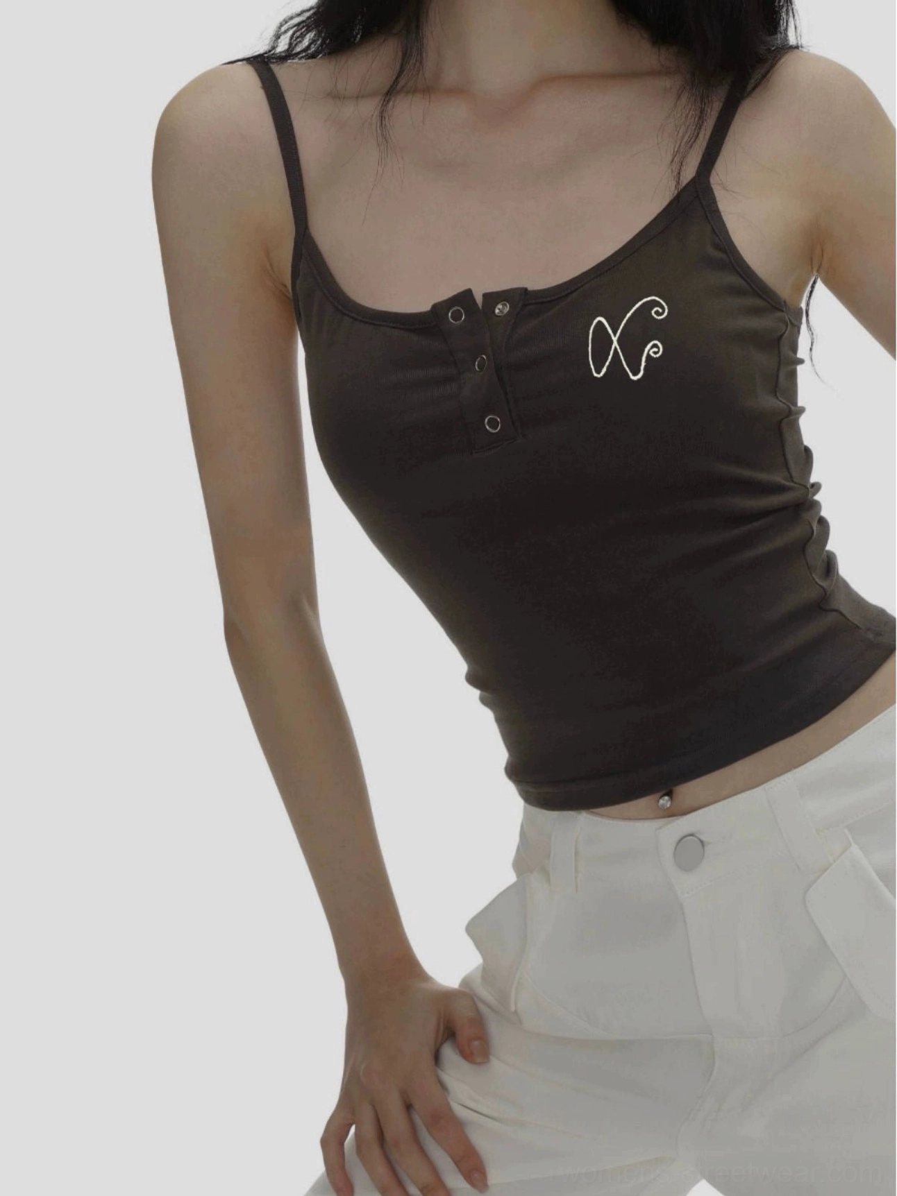 Close up of dark brown fitted cropped camisole with fine ribbed texture, spaghetti straps, Henley buttons, and XO embroidery