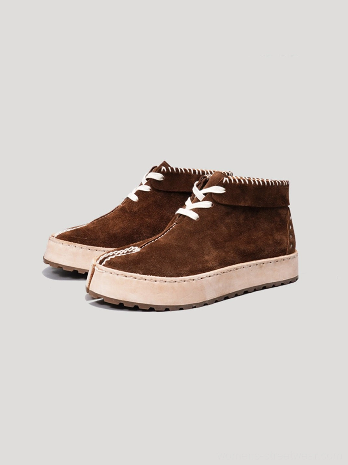 Dark brown split-toe suede-finish leather chukka boots shown from the front with white laces and contrast stitching