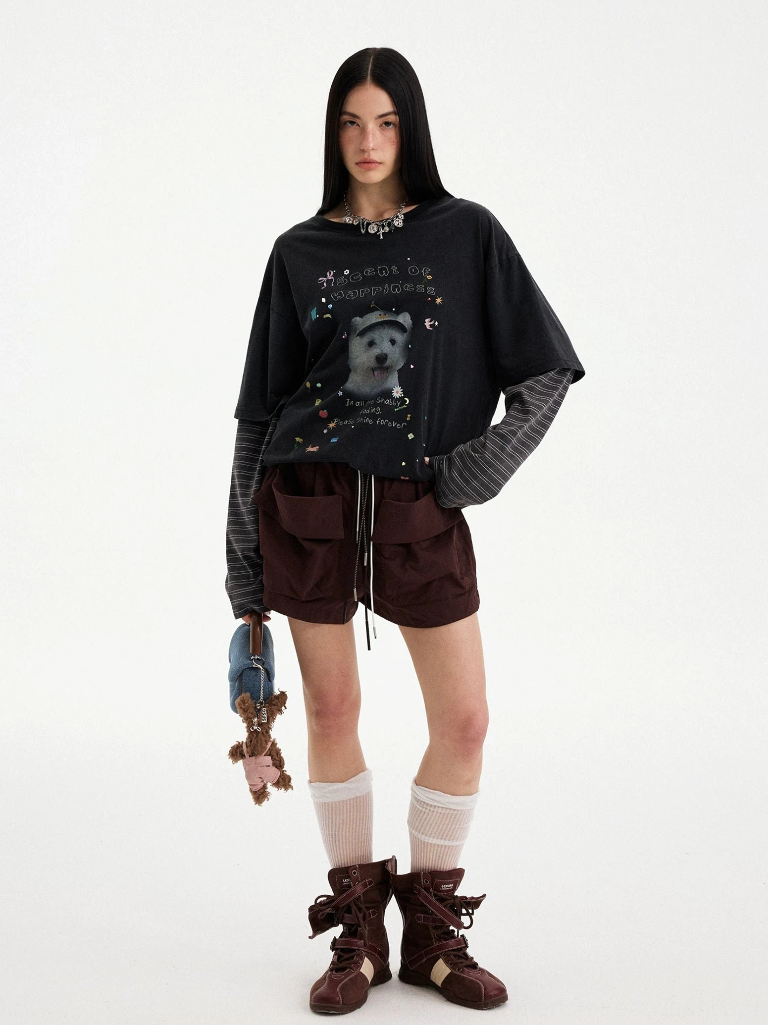 Dark brown utility cargo shorts styled with a layered graphic tee, cute bag charms, and contemporary Korean streetwear accessories