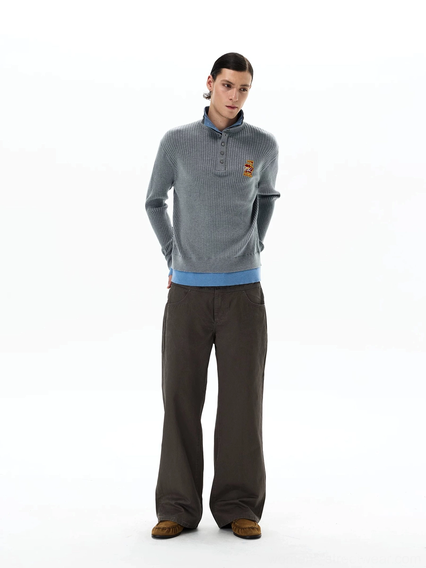 Full front outfit view featuring dark brown wide-leg chino streetwear pants, gray knit polo, and casual brown loafers