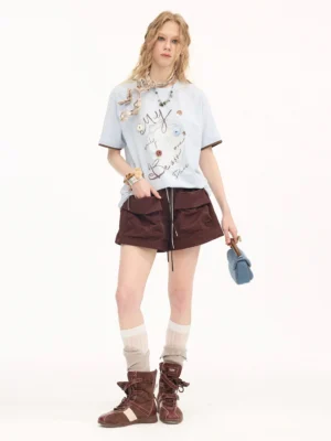 Dark brown women’s utility cargo shorts with oversized flap pockets, adjustable drawstring waist, and relaxed streetwear fit styled with a graphic tee