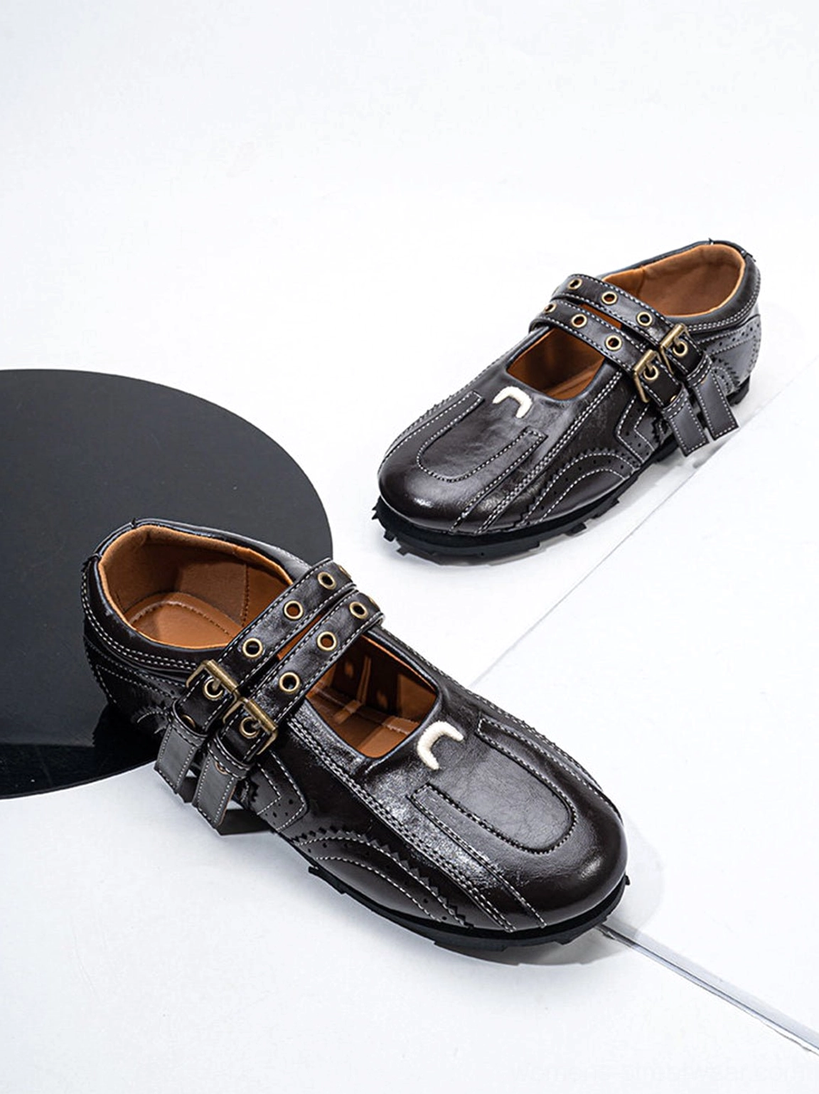 Dark coffee double-buckle flat shoes with square toe stud accents and decorative stitching
