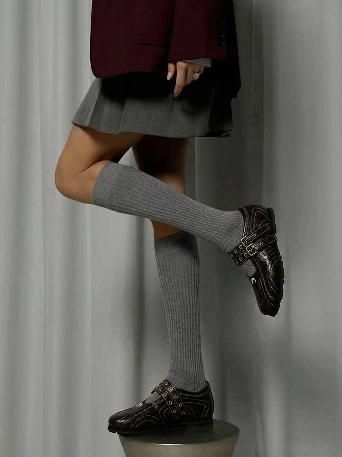 Dark coffee double-buckle square-toe flats styled with grey knee-high socks and a preppy streetwear outfit