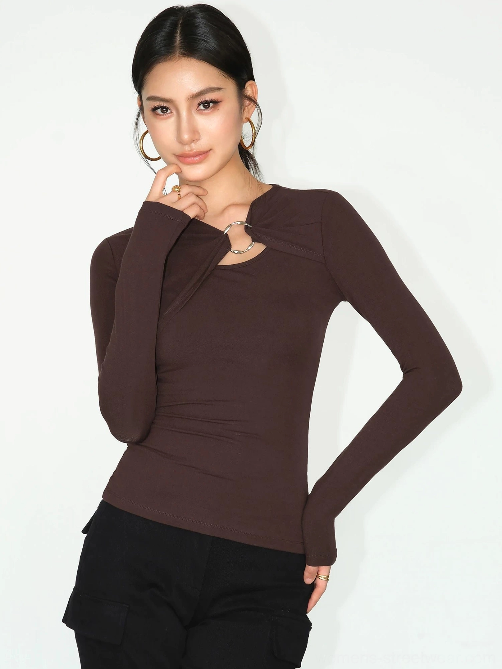 Dark coffee twist front metal ring knit top styled with black cargo pants for avant garde streetwear