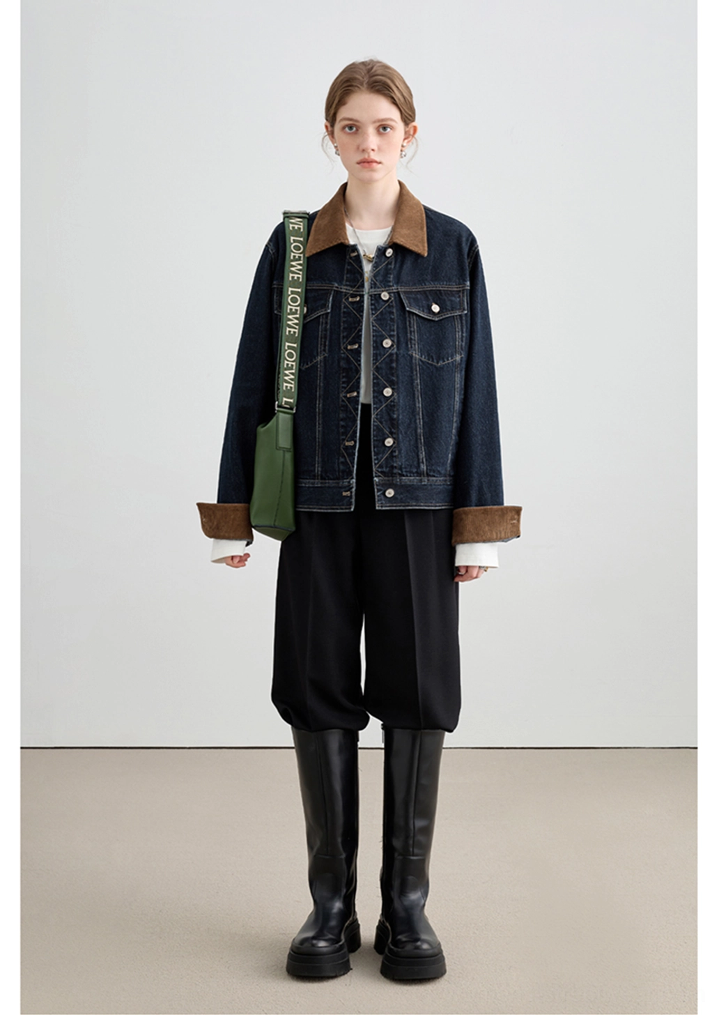Dark denim jacket with warm brown collar trim and statement cuffs for modern Korean street style