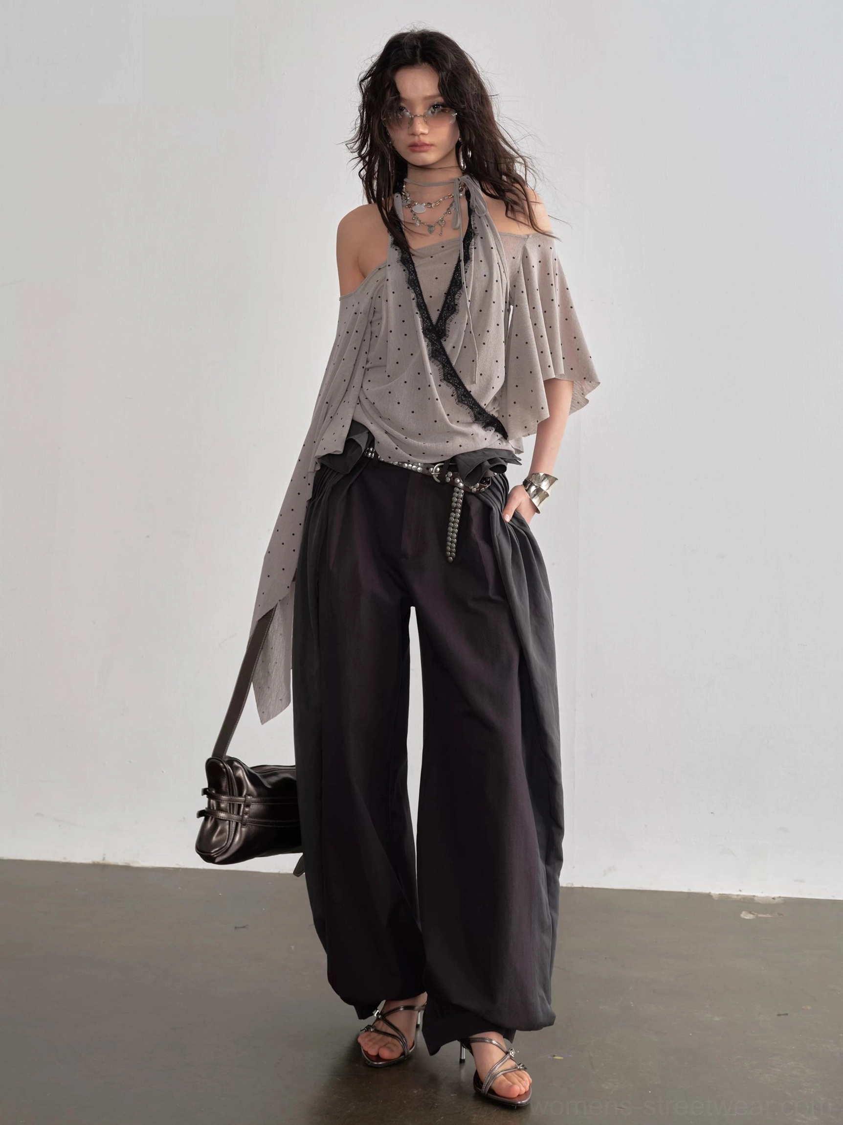 Dark gray balloon tie waist streetwear pants front view styled with off shoulder top and strappy heels
