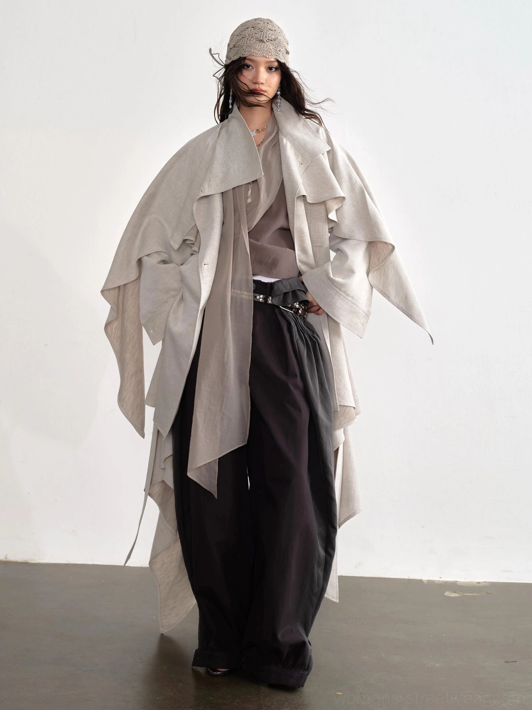 Dark gray layered balloon pants styled with oversized trench coat in an avant garde streetwear outfit