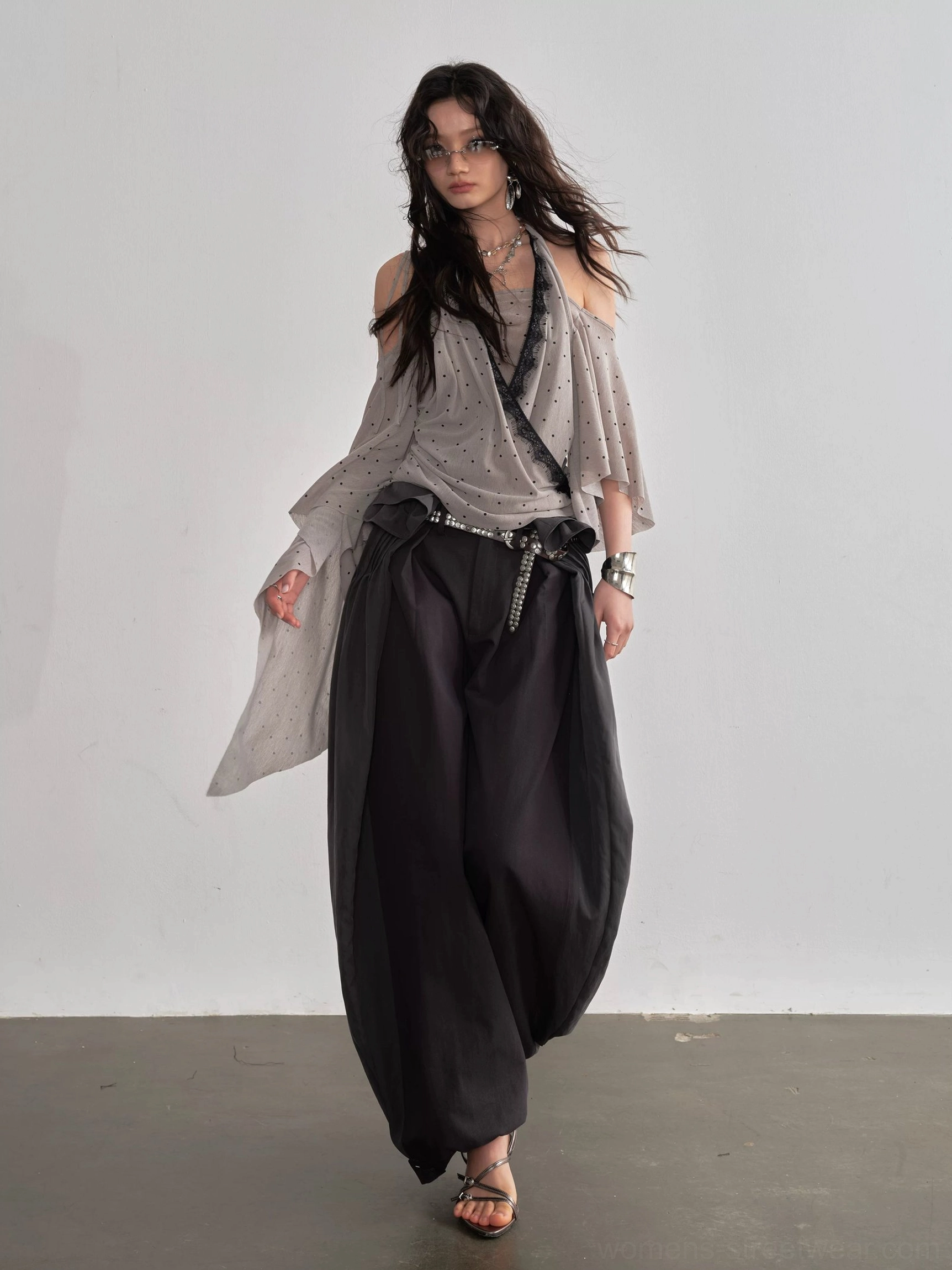 Dark gray high waisted balloon streetwear pants front walking view with off shoulder gray top