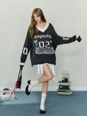 Dark gray oversized birthday cake V-neck knit sweater with off-white collar and cuffs styled with white mini skirt and Mary Jane shoes