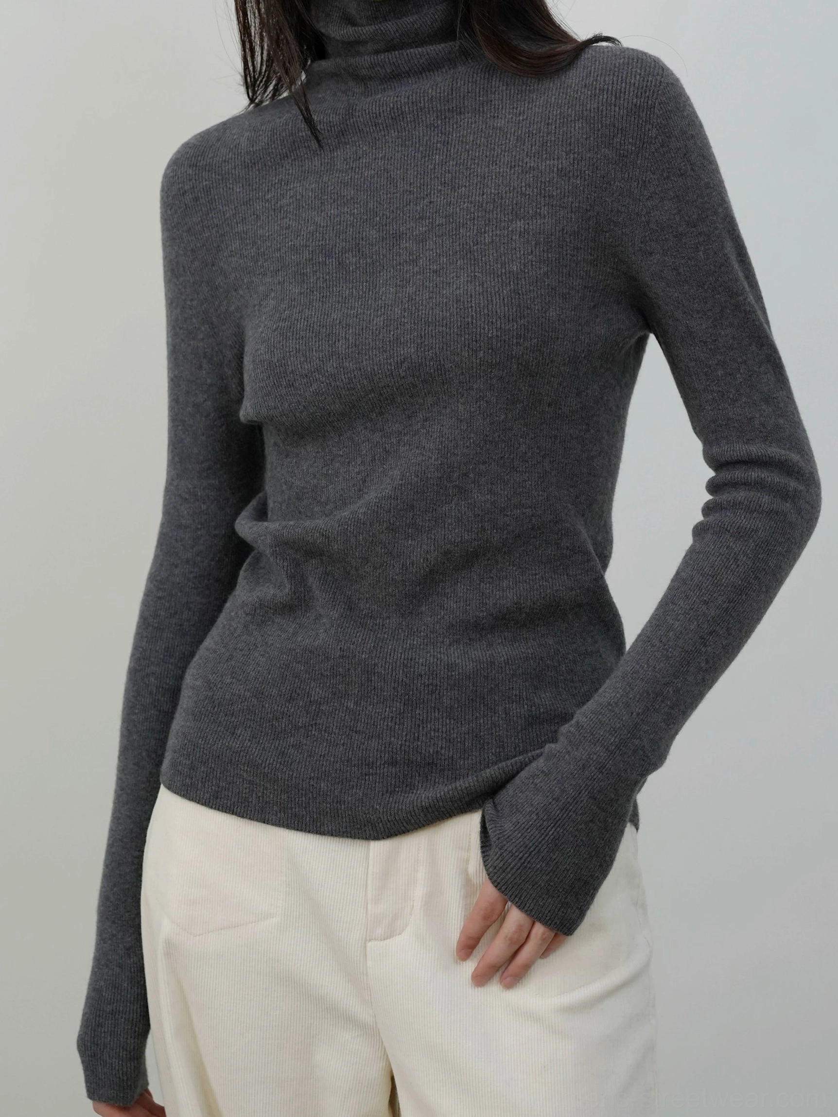 Dark heather gray fitted ribbed mock neck knit sweater styled as an everyday lightweight base layer