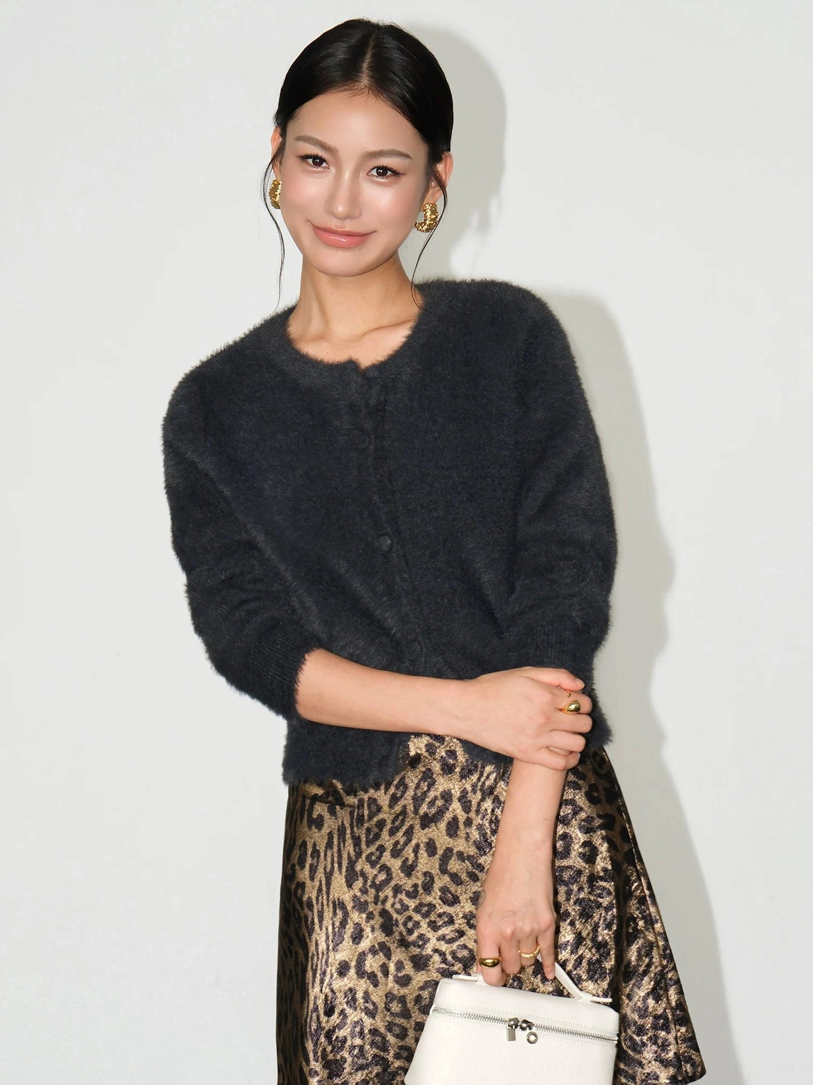 Dark gray fuzzy cropped cardigan with cozy plush knit texture for monochrome streetwear and layered fashion looks