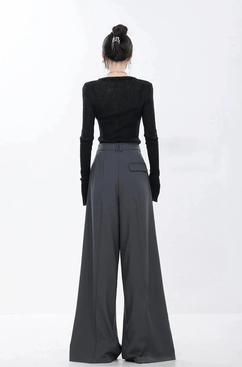 Back view of dark gray high-rise wide-leg trousers showing the clean waistline and rear pocket detail