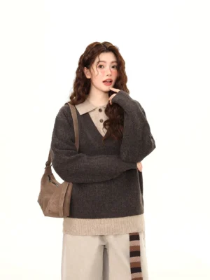 Dark gray layered polo collar knit sweater with contrast hem shown on model in a front three-quarter streetwear outfit