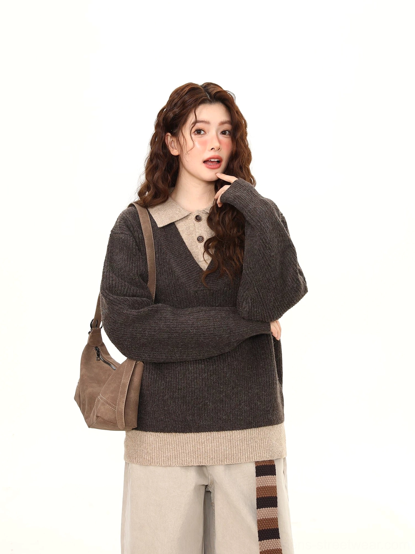 Dark gray layered polo collar knit sweater with contrast hem shown on model in a front three-quarter streetwear outfit