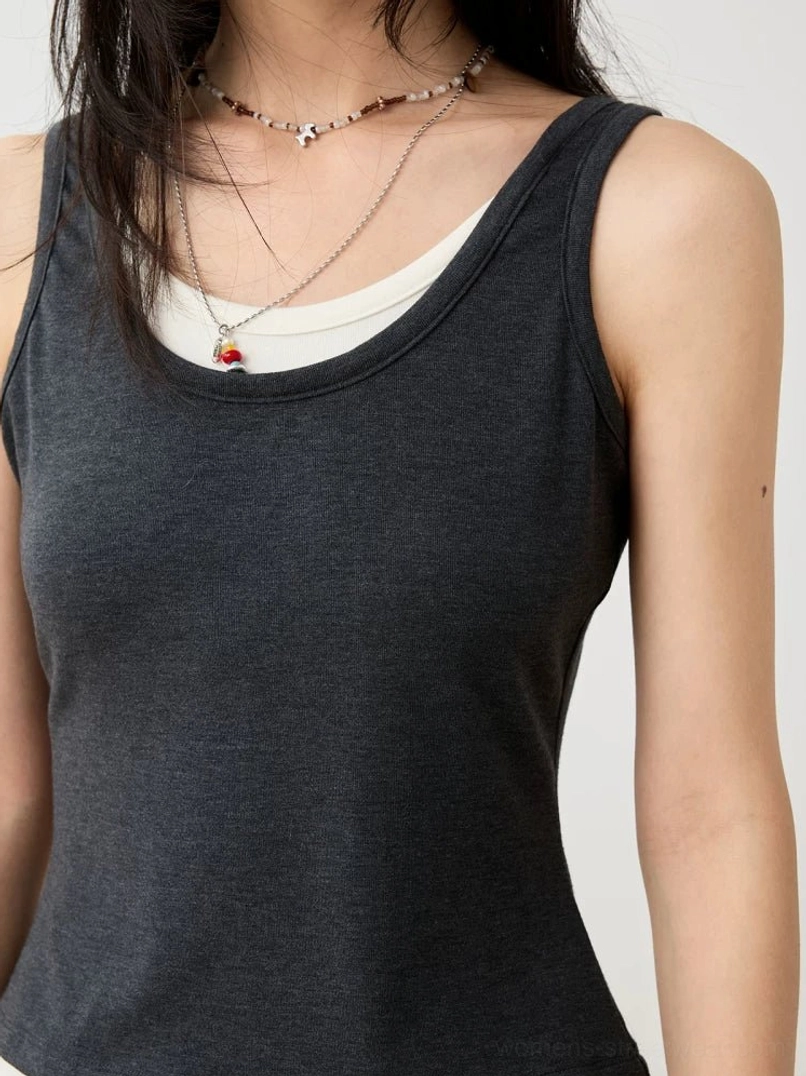 Close-up of dark gray ribbed knit layered scoop neckline on fitted streetwear tank top