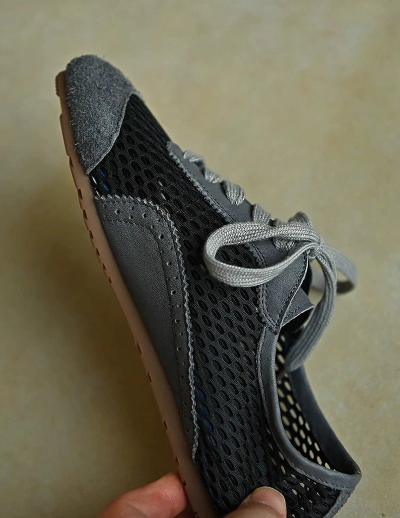 Dark gray mesh suede lace-up streetwear sneakers with breathable perforated panels, layered leather accents, and low-profile sole