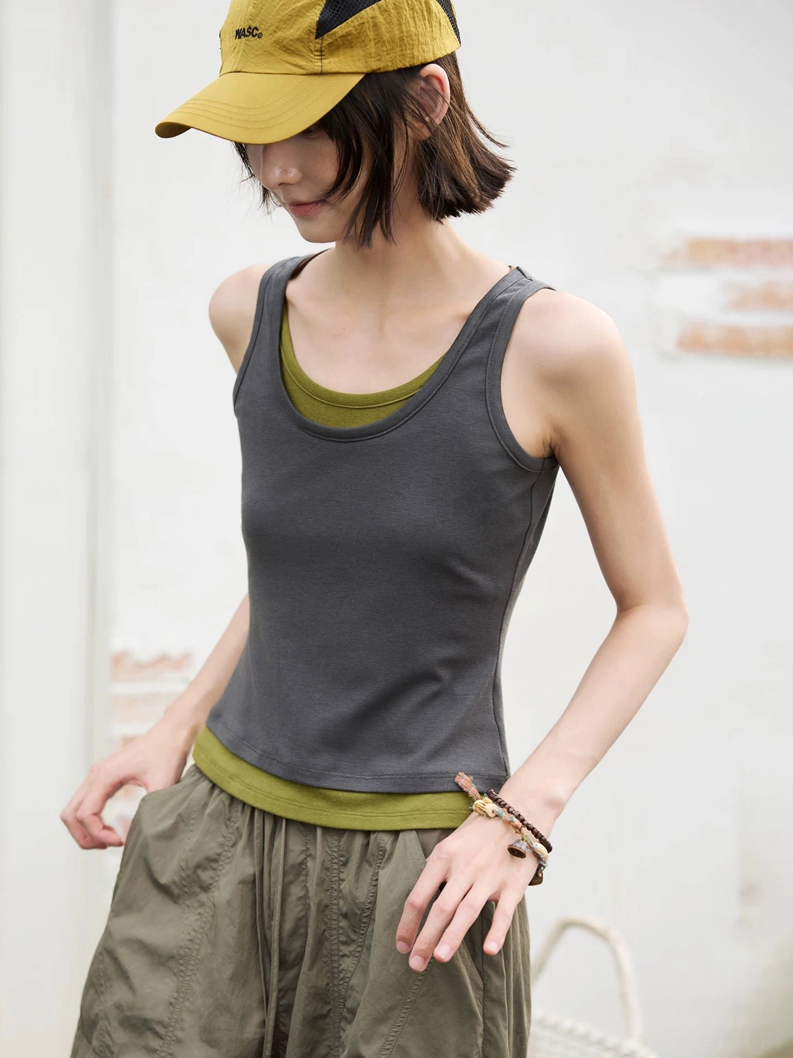 Dark gray and olive green contrast layered scoop neck fitted tank top front view with yellow cap