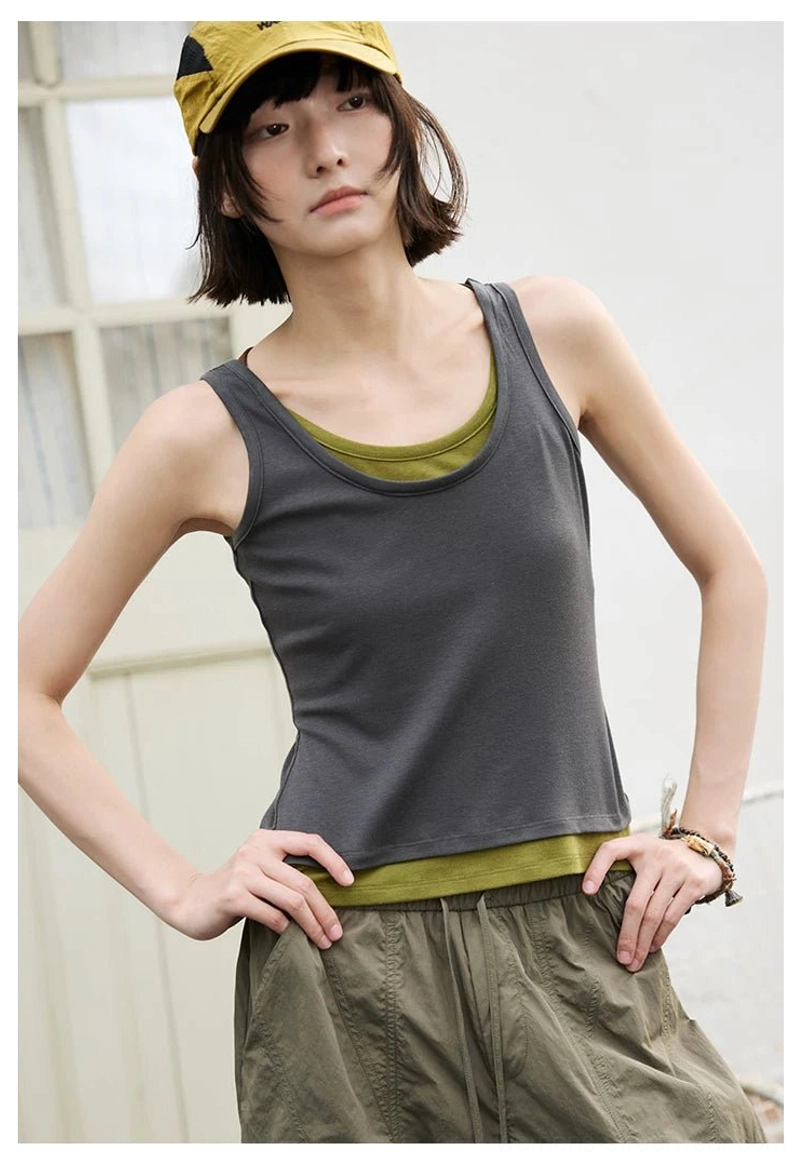 Dark gray and olive green fitted layered scoop neck tank top styled with cargo pants and yellow cap
