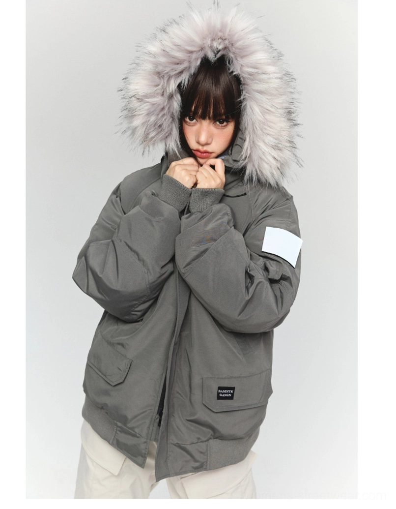 Front close-up of a dark gray oversized faux fur trimmed hooded parka with white sleeve patch ribbed cuffs and flap pockets