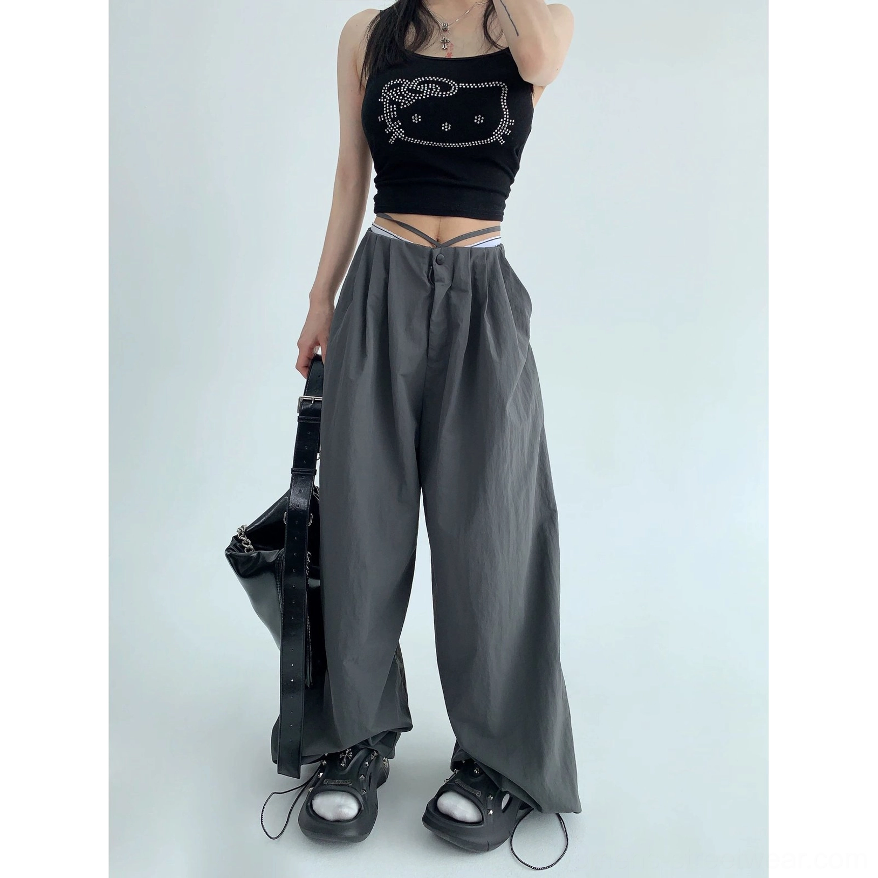 Dark gray parachute wide-leg pants product detail with relaxed pleats, fluid fabric, and contemporary streetwear fit