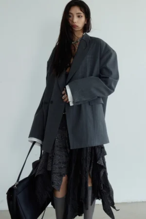 Dark gray relaxed striped blazer shown from the side with double-breasted front padded shoulders and loose Korean streetwear silhouette