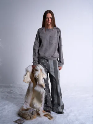 Full body front view of dark gray stars and stripes wide leg streetwear jeans styled with a matching gray sweatshirt