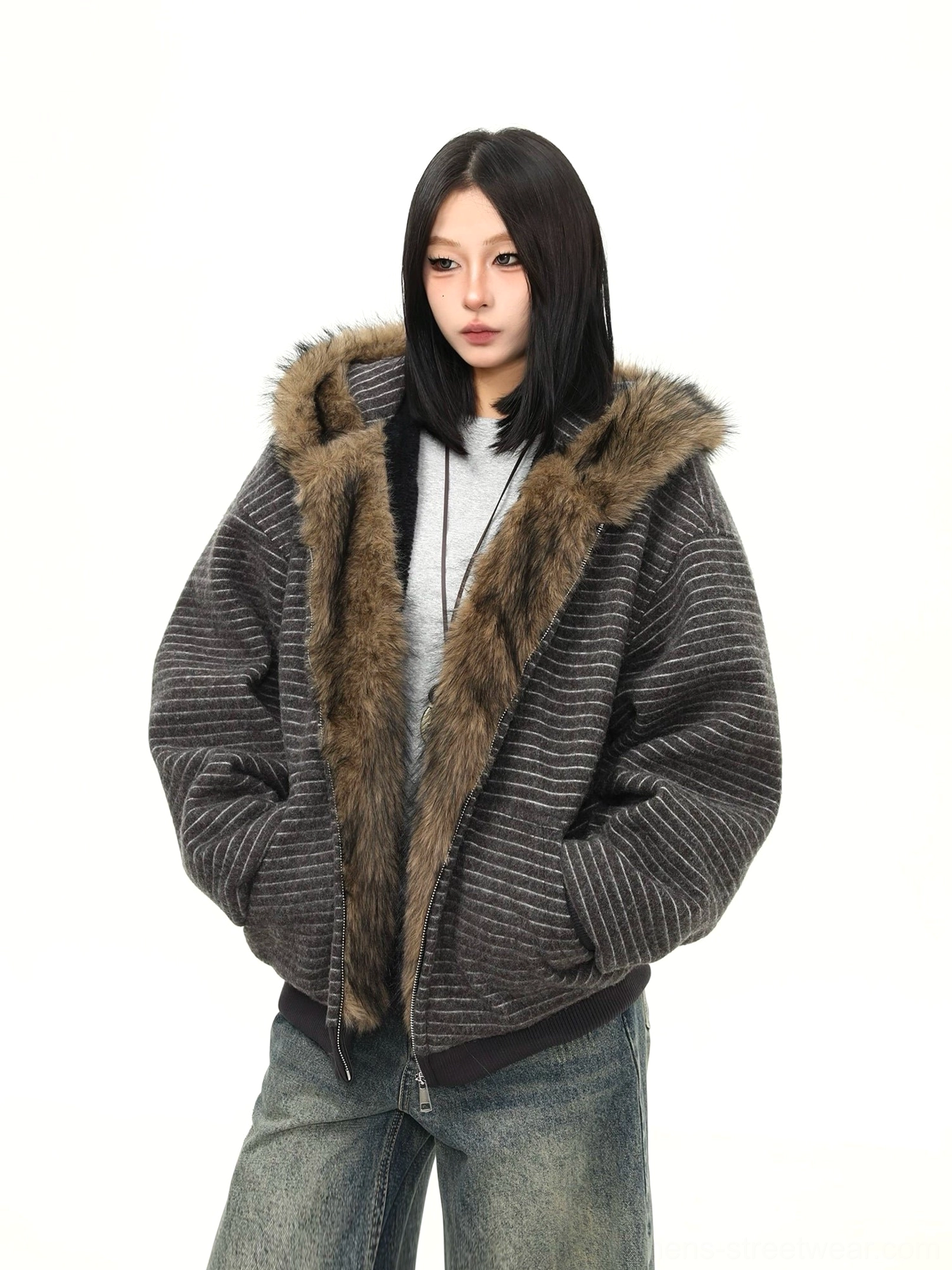Dark gray striped faux fur hooded jacket with brown fuzzy trim styled as a relaxed Korean streetwear winter layer