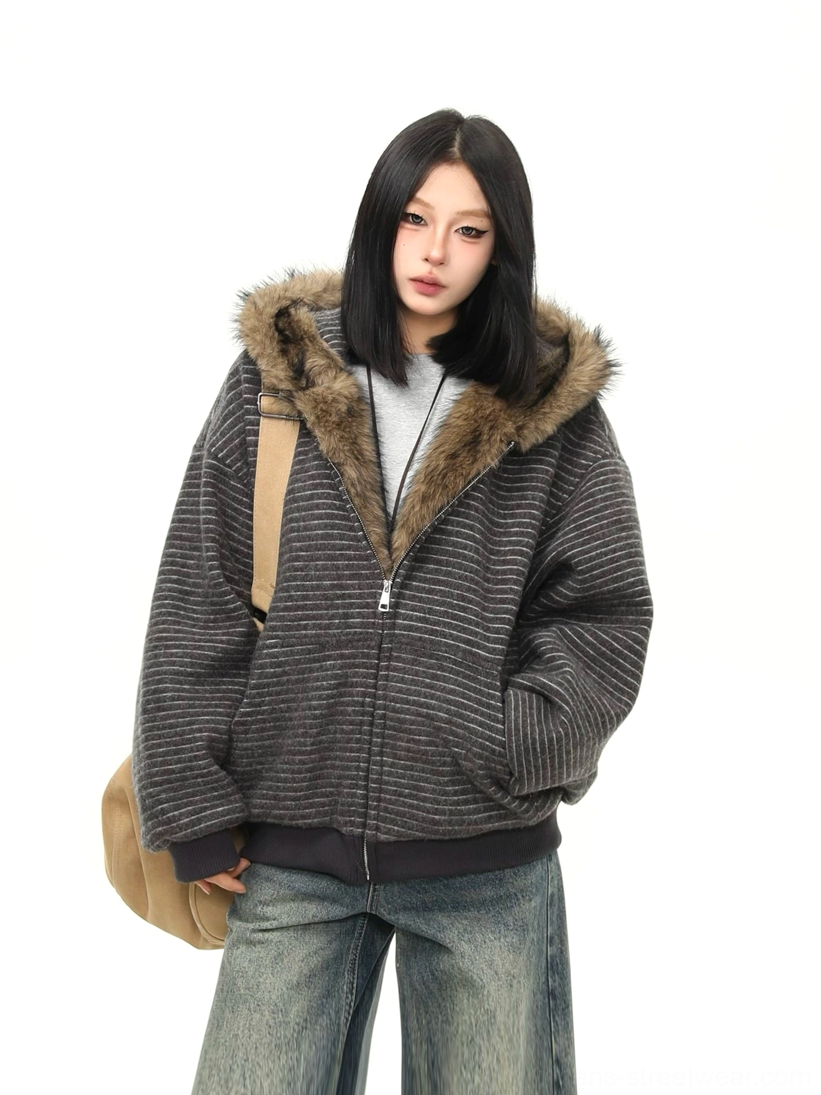 Dark gray striped faux fur hooded streetwear jacket styled with vintage wide leg jeans and a tan tote bag