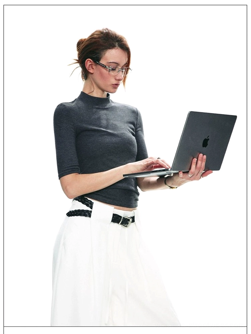 Dark gray fitted TENCEL mock neck half-sleeve top worn with white trousers for a modern office streetwear outfit